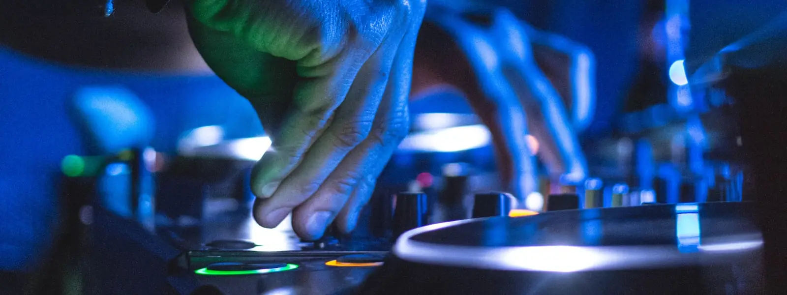 Hands on a DJ controller's performance pads