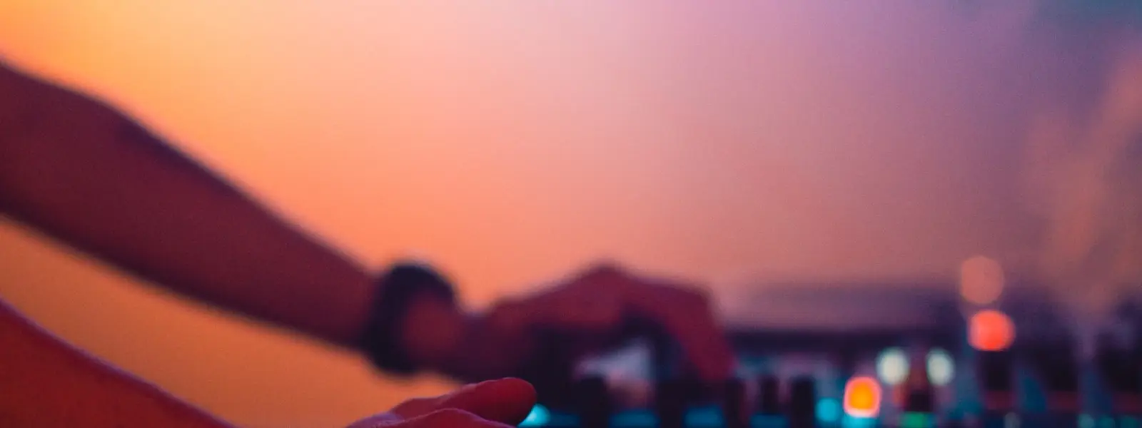 A two-channel DJ controller lit from above