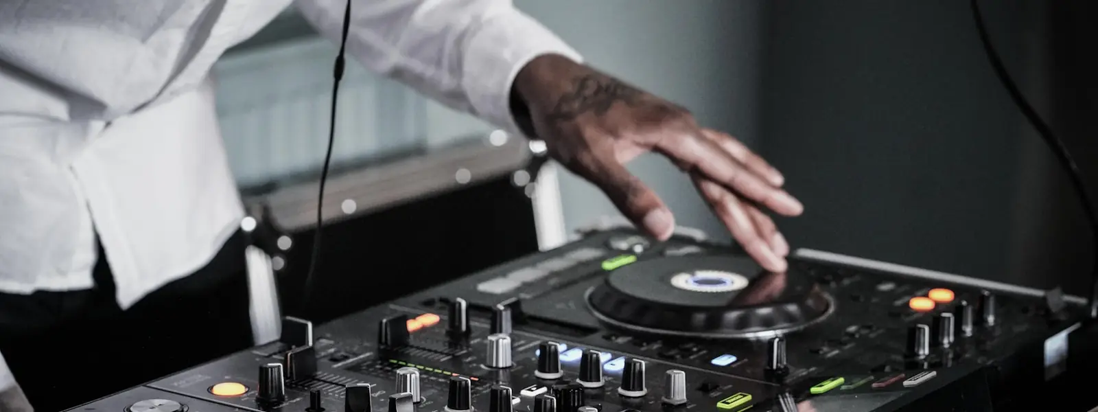A hand on a mixer channel