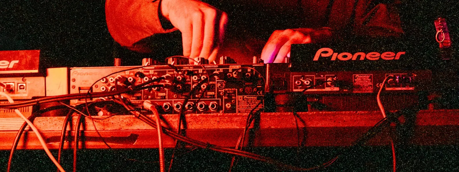 A DJ adjusting EQ on a mixer