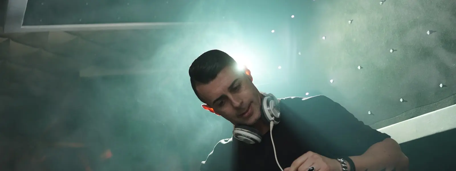 A DJ playing in a club booth